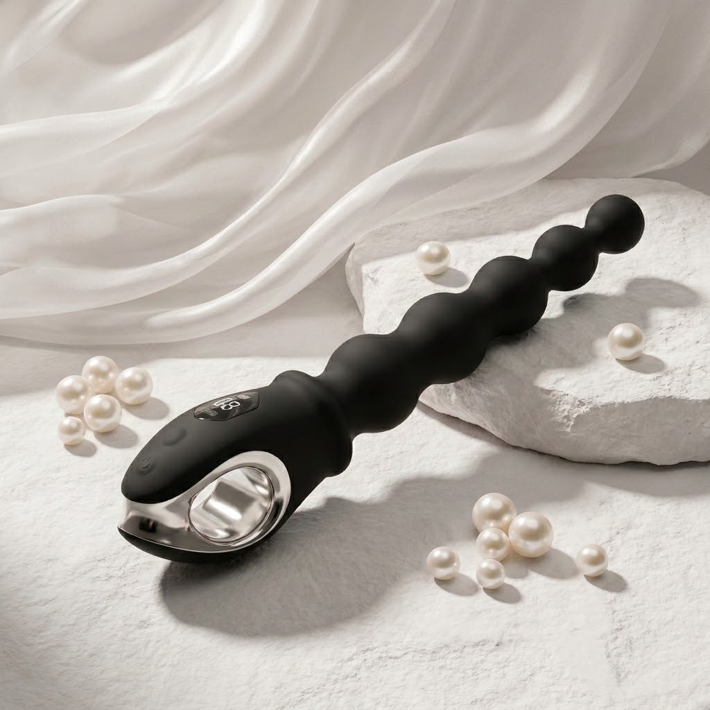 Velora black beaded vibrator displayed with pearls and white fabric